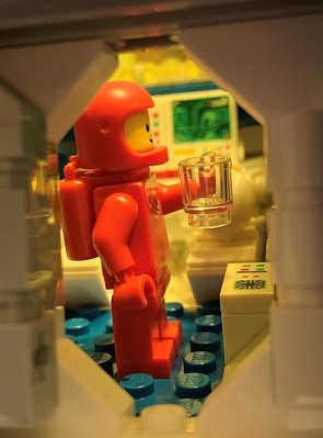 Space minifigure hold a cup